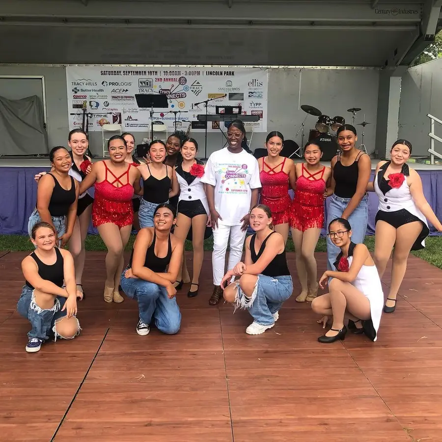 A youth dance team poses on the Tracy Connects stage