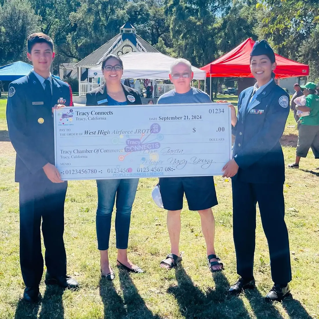West High Air Force JROTC cadets hold an oversized Tracy Connects award check