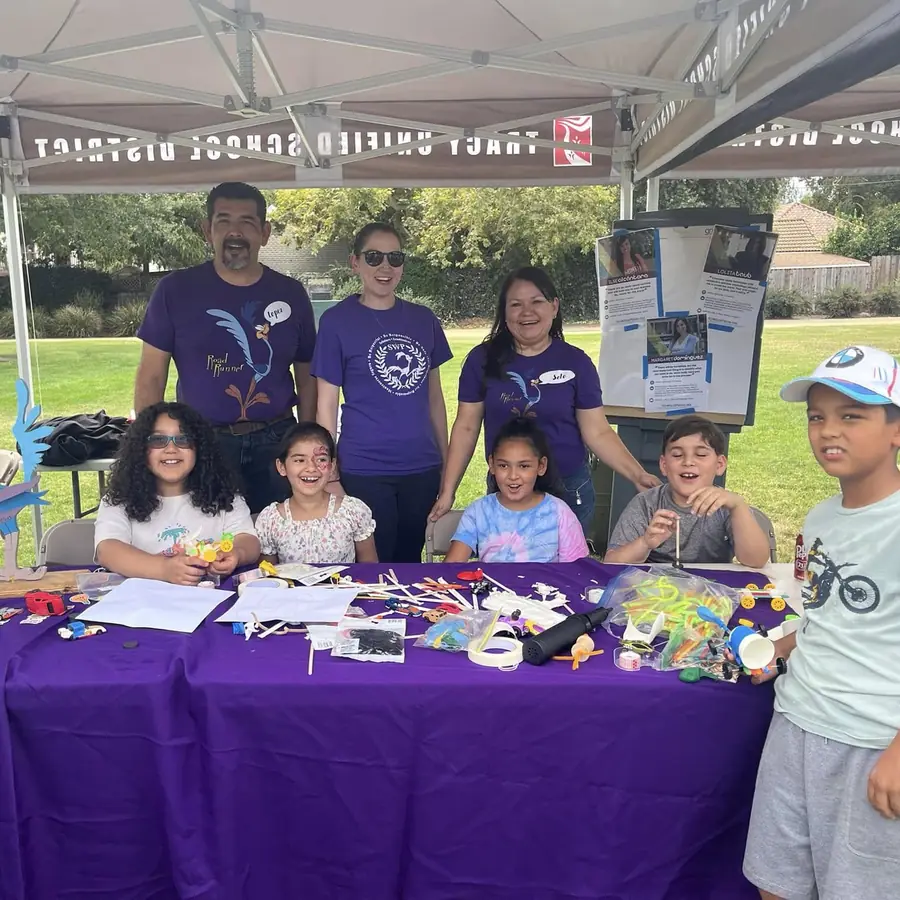 Kids building small cars at the Tracy Unified School District STEM table